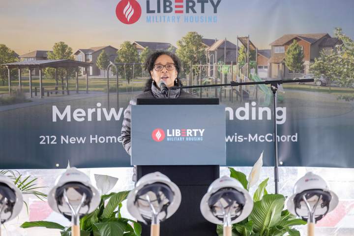 Congress Women, Marilyn Strickland, pictured speaking at a podium at the Joint Base Lewis McChord Groundbreaking