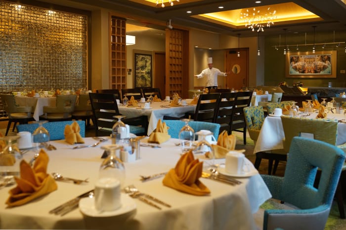 Dining room tables set for dinner service at All Seasons Birmingham in Birmingham, Michigan