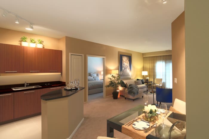 Model living room and kitchen at All Seasons Birmingham in Birmingham, Michigan