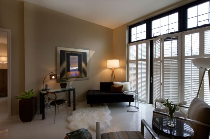 Beautiful living room with white accents at All Seasons Birmingham in Birmingham, Michigan
