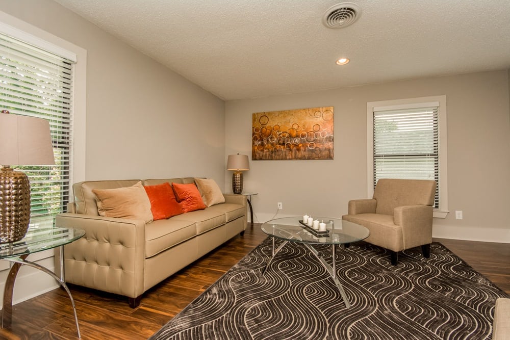 A furnished living room with wood flooring in an apartment at Dunwoody Exchange in Atlanta, Georgia
