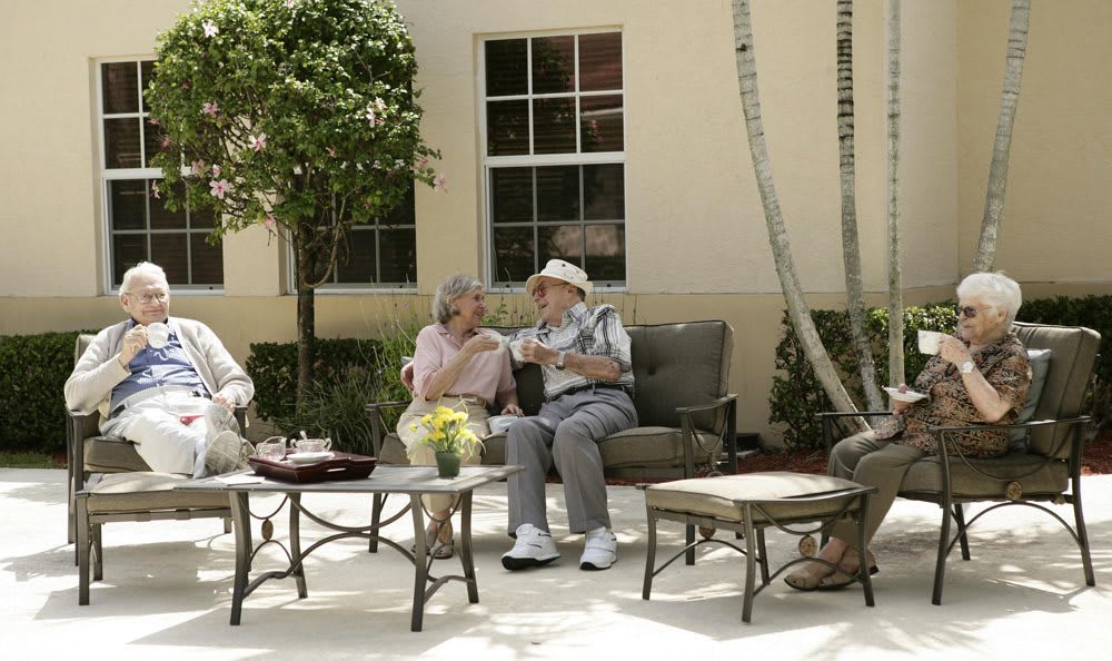 Relax outside at our senior living facility in Coral Springs
