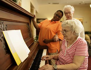 senior living residents play piano in Rock Hill