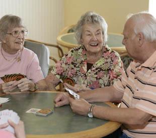 senior living residents enjoying a game of cards in Lady Lake