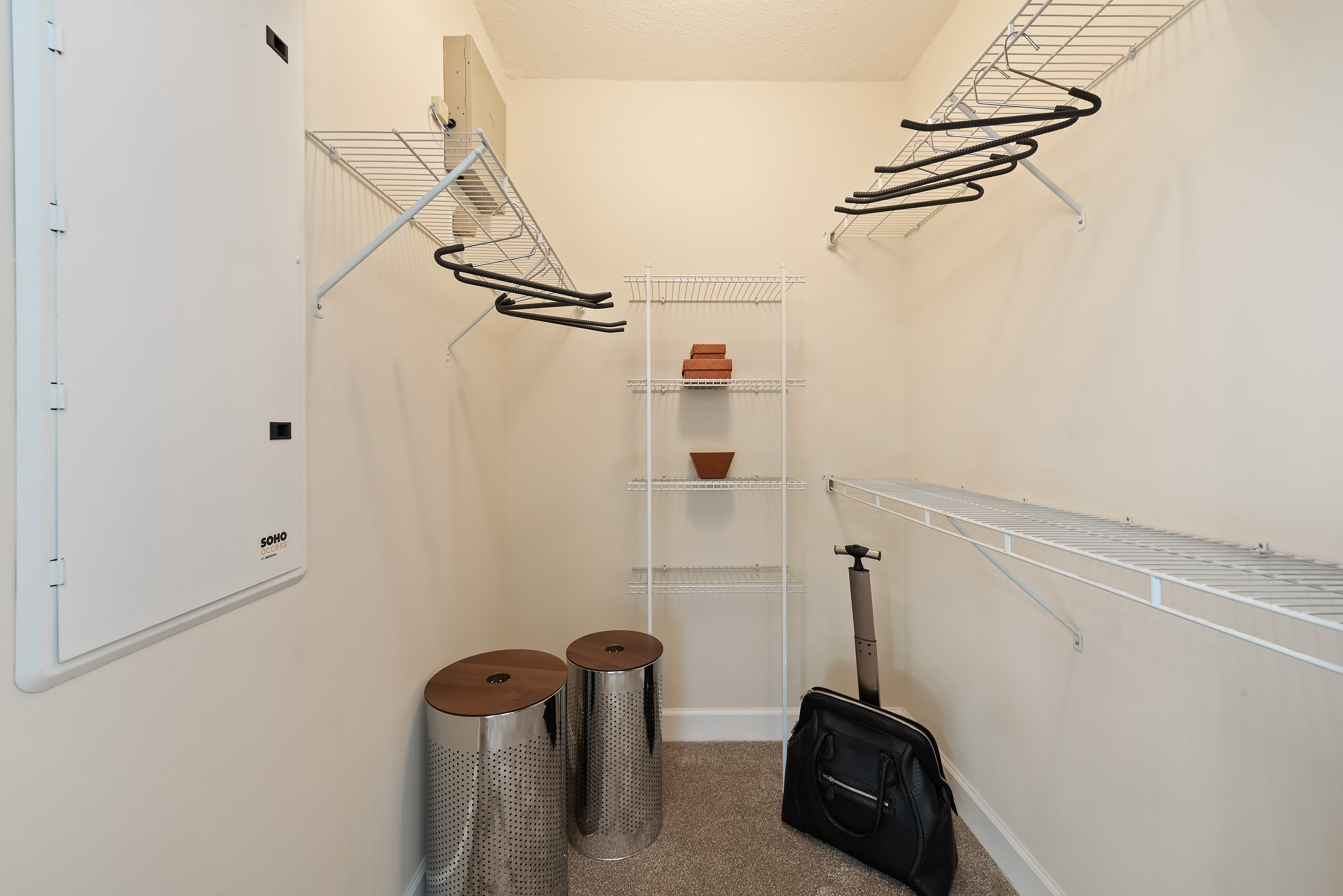 Interior of a large walk-in closet at The Residences at Lakehouse in Miami Lakes, Florida