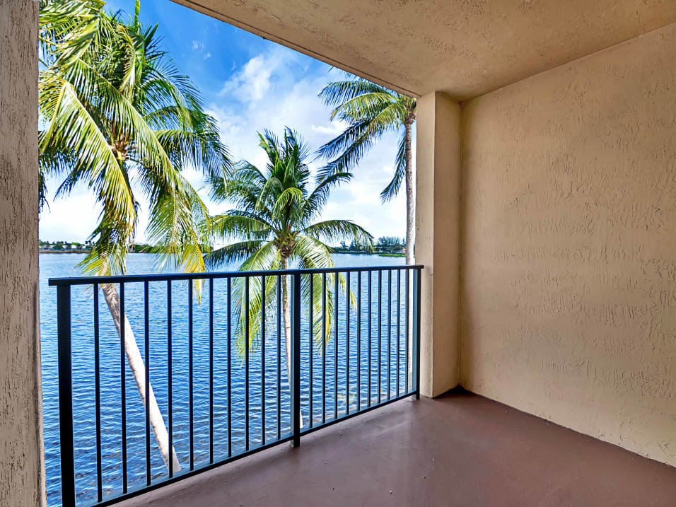 Private balcony with stunning lake views at St. Tropez Apartments in Miami Lakes, Florida