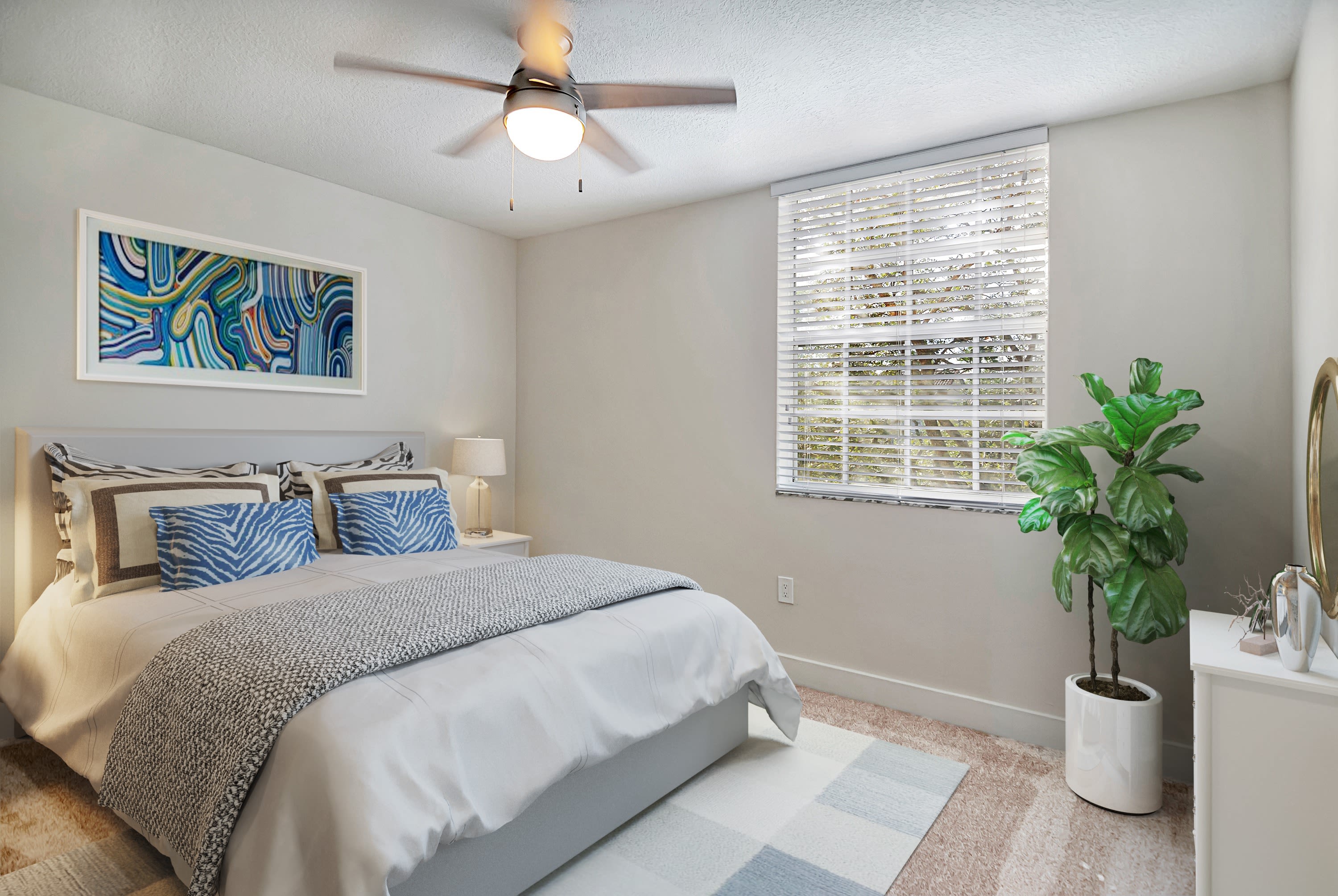 Model bedroom with ceiling fan at St. Tropez Apartments in Miami Lakes, Florida