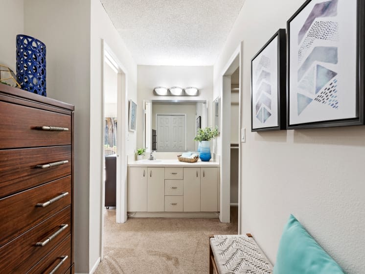 Dresser nook and bathroom vanity at Executive Apartments in Miami Lakes, Florida