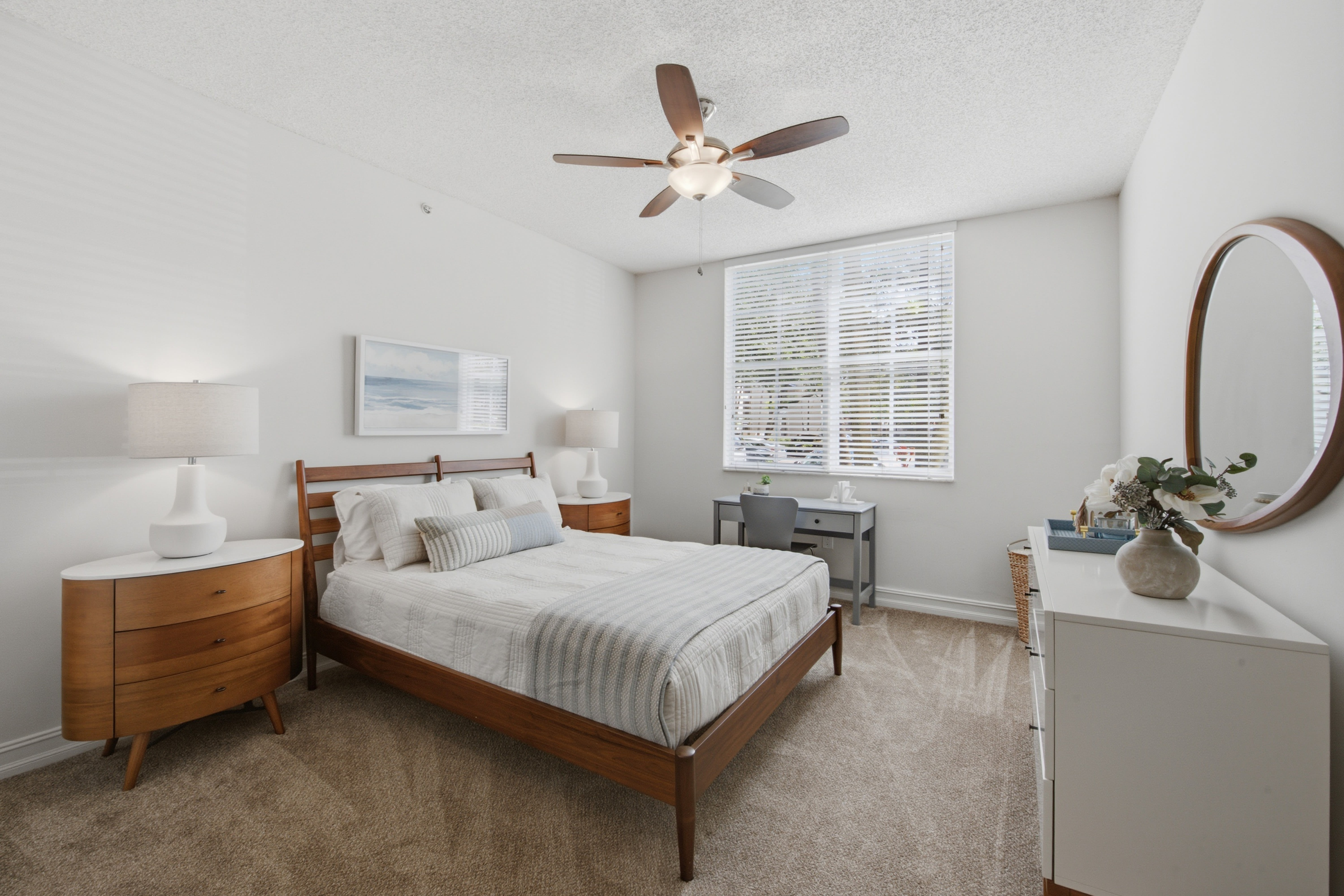 Model bedroom with ceiling fan and walk-in closet at Fountain House Apartments in Miami Lakes, Florida