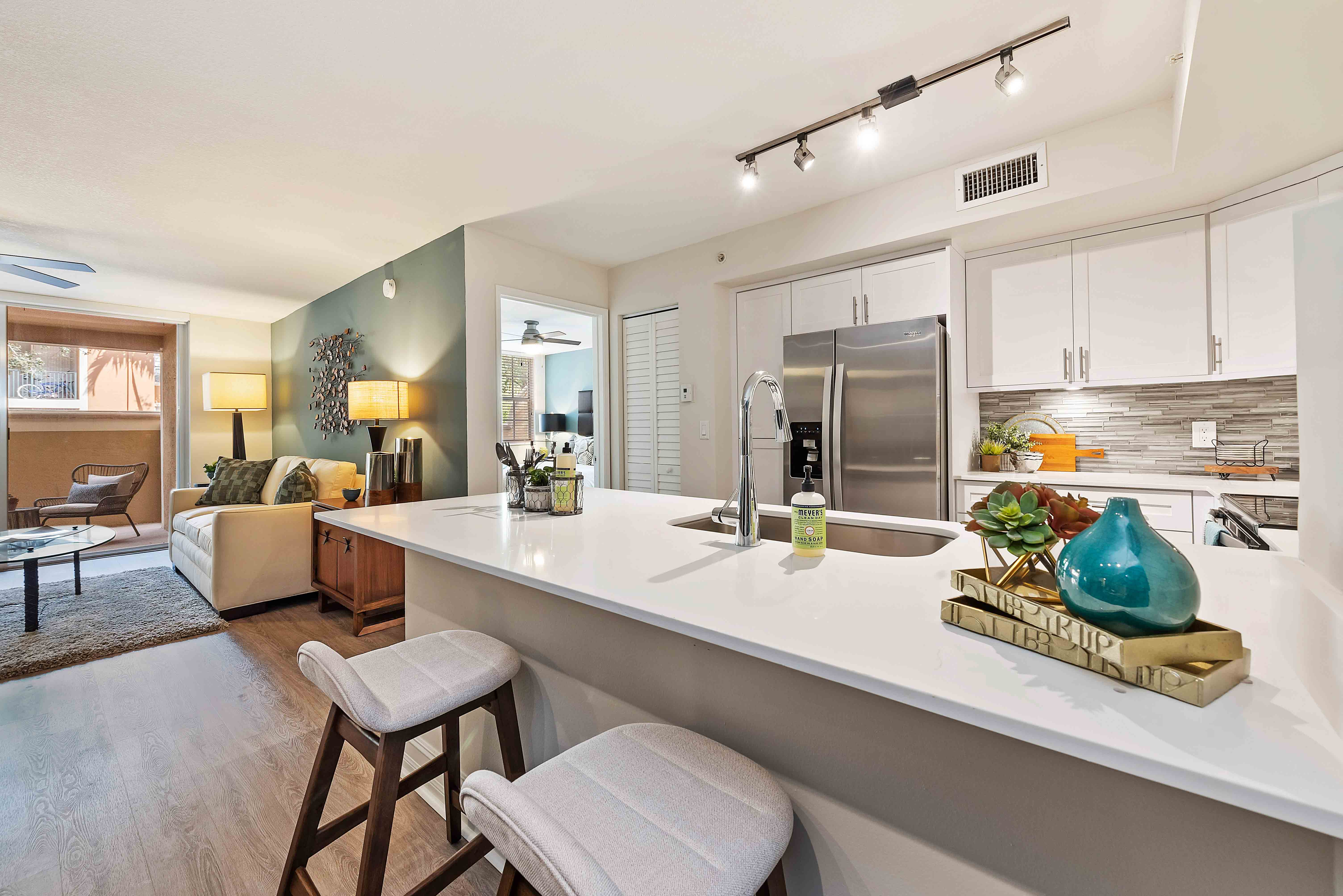 Model kitchen with open concept to living room at Crescent House Apartments in Miami Lakes, Florida