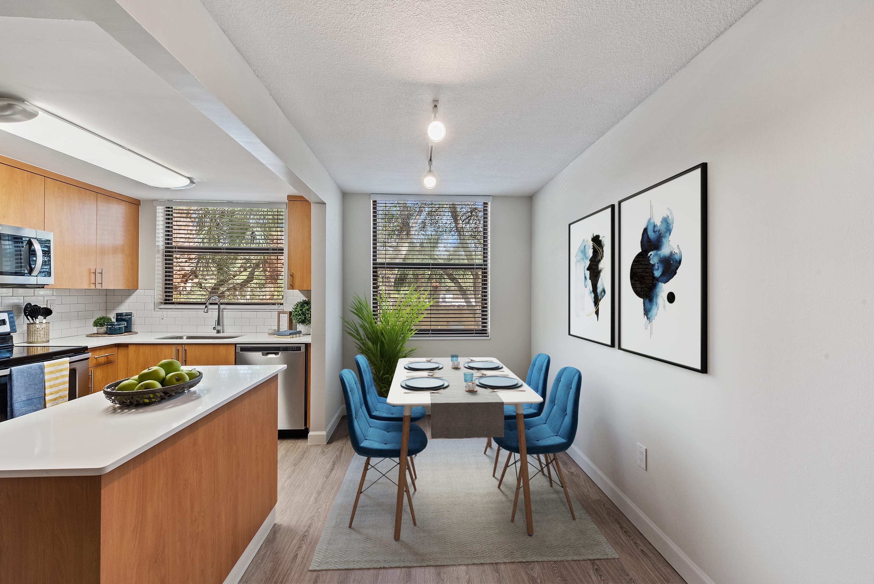 Kitchen with island overlooking the dining area at Bull Run Apartments in Miami Lakes, Florida