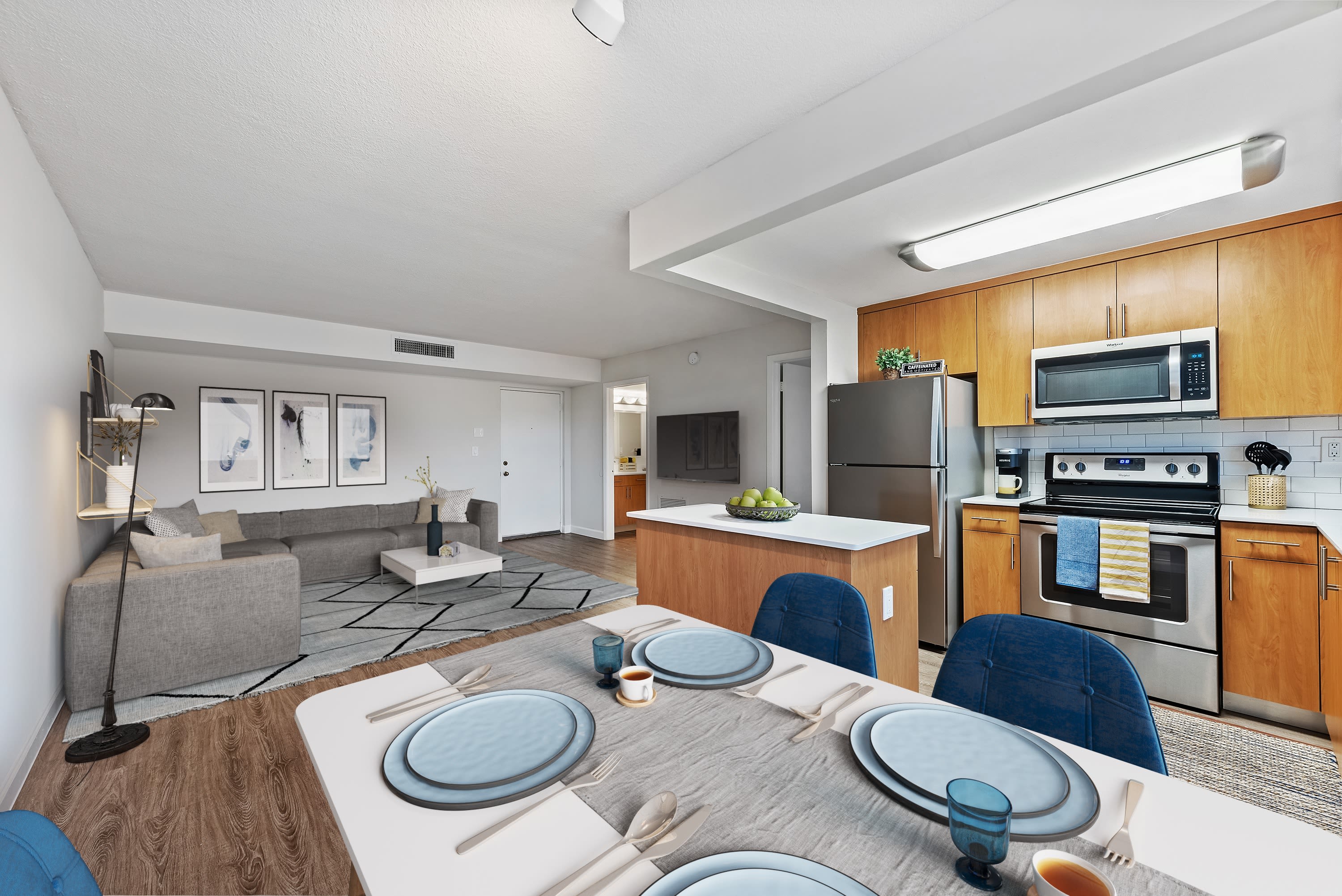 Open space floor plan with living room, dining room, and kitchen at Bull Run Apartments in Miami Lakes, Florida