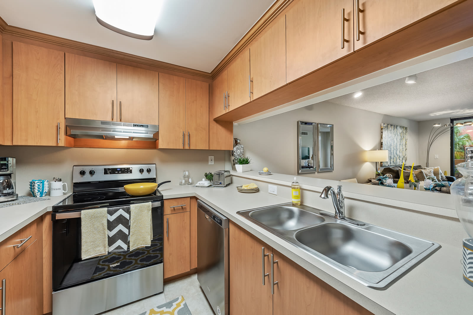 Fully equipped kitchen with stainless steel appliances at Meadow Walk Apartments in Miami Lakes, Florida