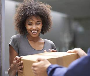 A woman grabbing a box at Golden State Storage.