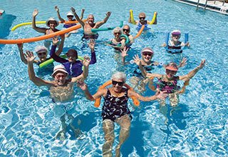 Senior living residents in Allen enjoy pool aerobics games and exercises