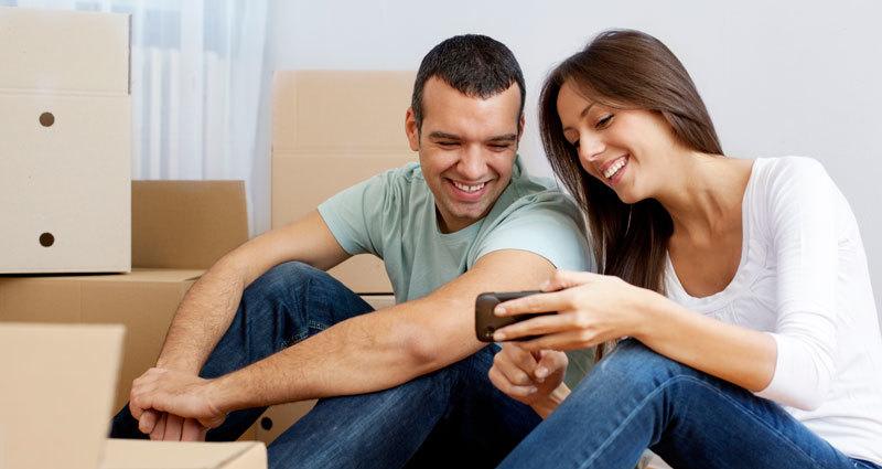 A couple looking up storage prices at StorAway Self Storage - Portsmouth Boulevard in Portsmouth, Virginia. 