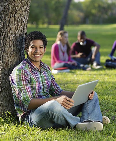 Students studying in the park near Douglass Gardens Apartments