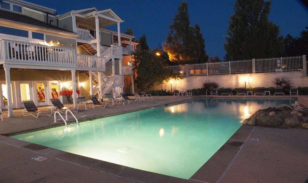 Pool view at night at Island Club Apartments