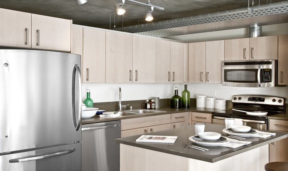 Fully equipped kitchen with a kitchen island at The Nolo at Stadium Place in Seattle, Washington