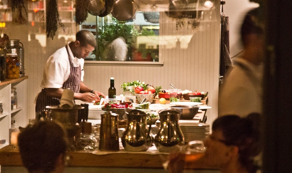 Servers setting up a restaurant for dinner service in Seattle, Washington near The Nolo at Stadium Place