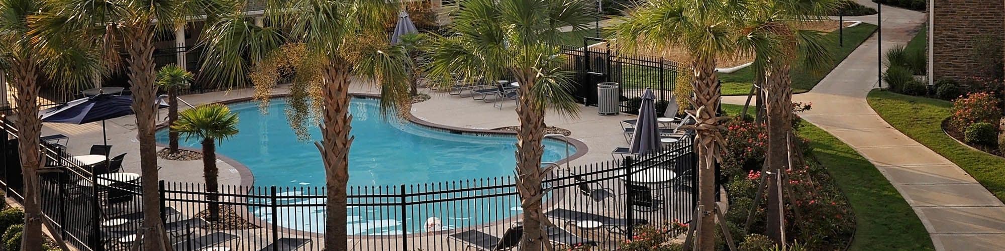 Relax by one of our two pools at Jamestown Place Apartment Homes.