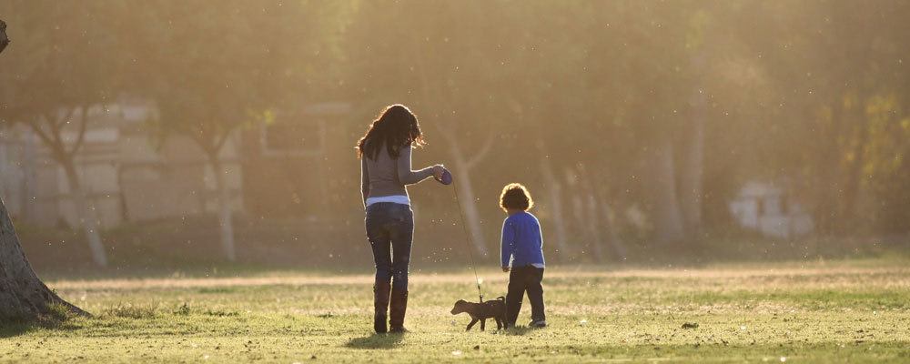 Mother and son walking their dog at Villa Broussard in Broussard, LA.