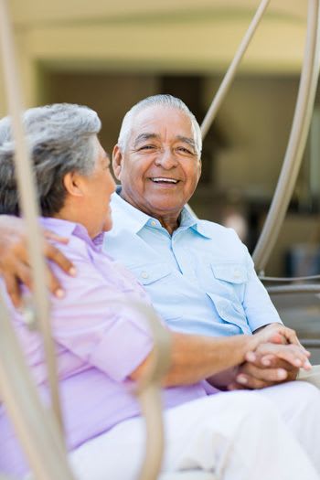 Couple sitting outside on a swing