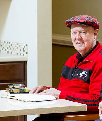 Resident reading a book at Madison Crossings in Madison, AL