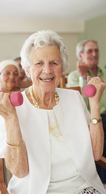 Woman exercising with weights at The Pearl at Fort Mill in Fort Mill, South Carolina