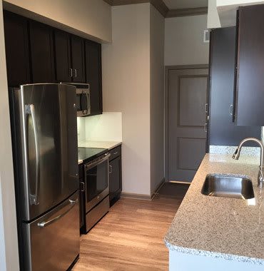 Kitchen With Stainless Steel Appliances And Wood Floor at Sunrise Briar Forest