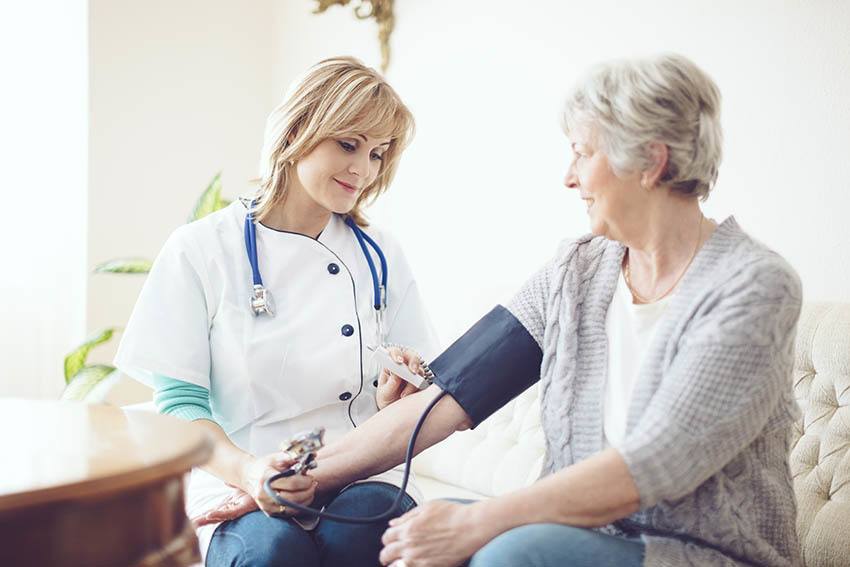 Registered Nurse and Licensed Nurses assist residents at The Ambassador of Scarsdale