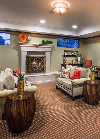 Relaxing common room with fireplace at the senior living community in Irvine