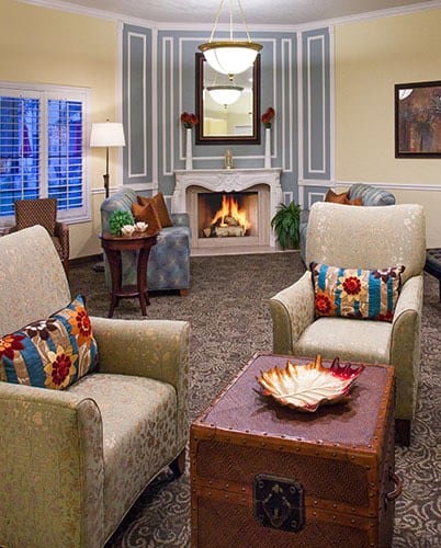 Cozy sitting area at by the fireplace at the senior living community in Salt Lake City