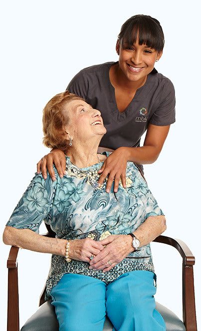Resident reading a book to grandchild at the senior living community in Seattle