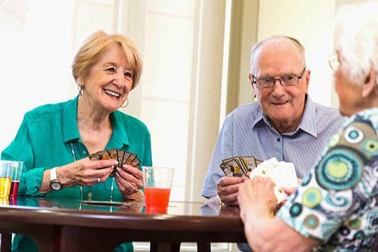 Playing cards with friends at American House Senior Living in Bloomfield Hills, MI