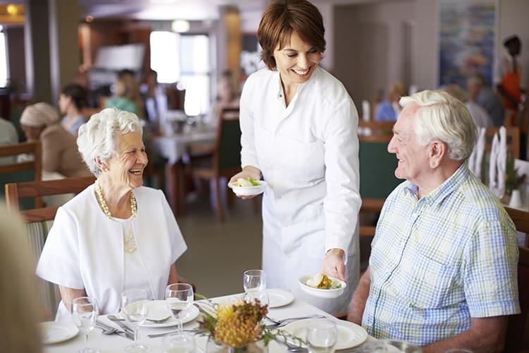 Senior living couple in Delaware assisted living dine together