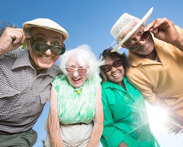 A smiling group of seniors enjoying the Regency Pacific lifestyle