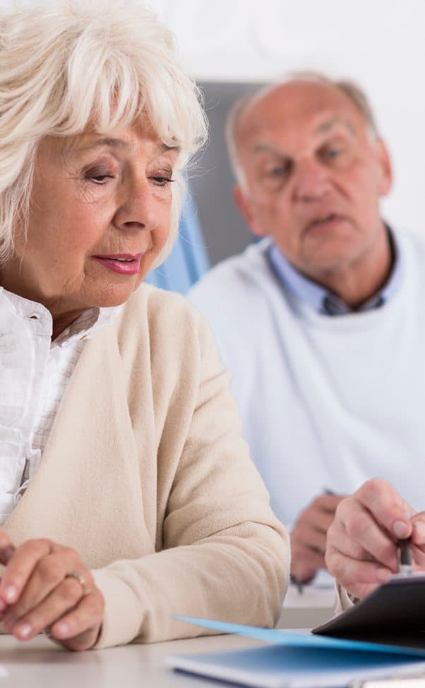 Veteran and his wife chatting about their senior living options with a Regency Pacific Management community director.