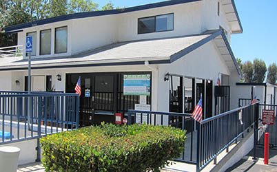Building from behind gate at American Mini Storage in Lake Forest, California
