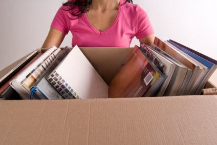 Woman taking handy packing tips from Storage World to pack her book