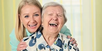 Mother and daughter enjoying a good laugh at one of our AssistedSenior.com communities