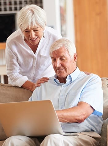 Couple considering their retirement options online - and looking into Grand Villa Senior Living communities