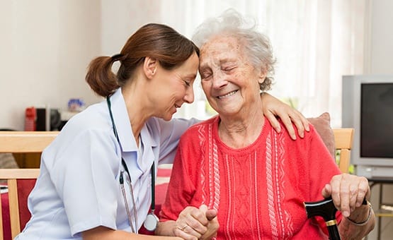 Nurse assisting an elderly lady at Grand Villa of Clearwater in Florida