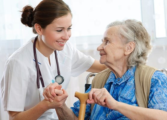 Nurse happily assisting an elderly lady at Grand Villa of Clearwater in Florida
