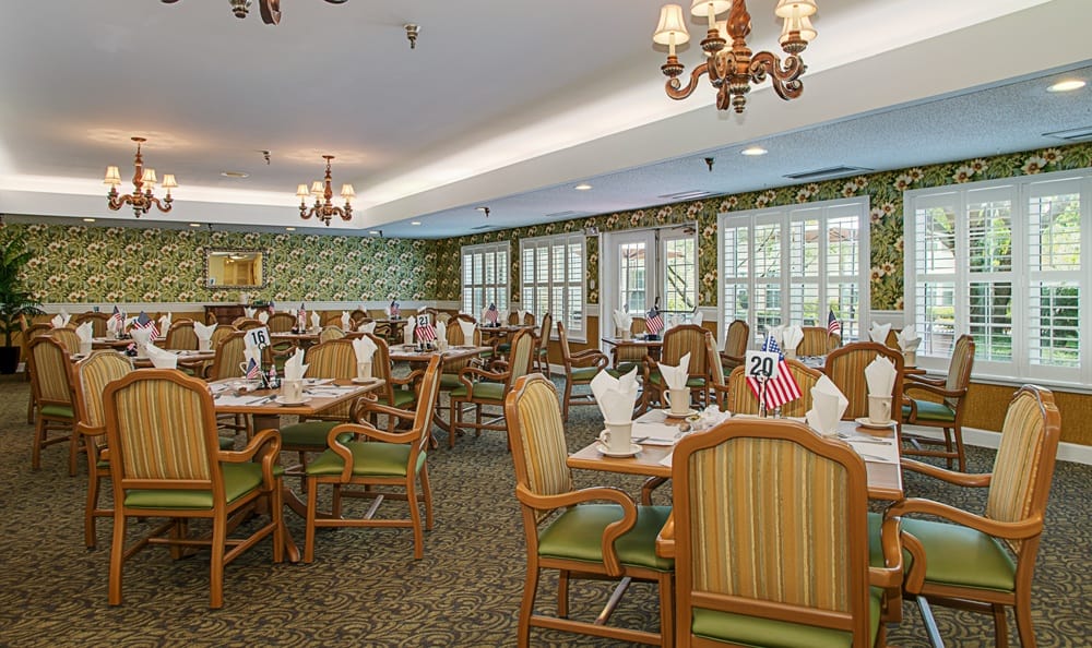 Dining hall with green accents at Grand Villa of Largo in Florida