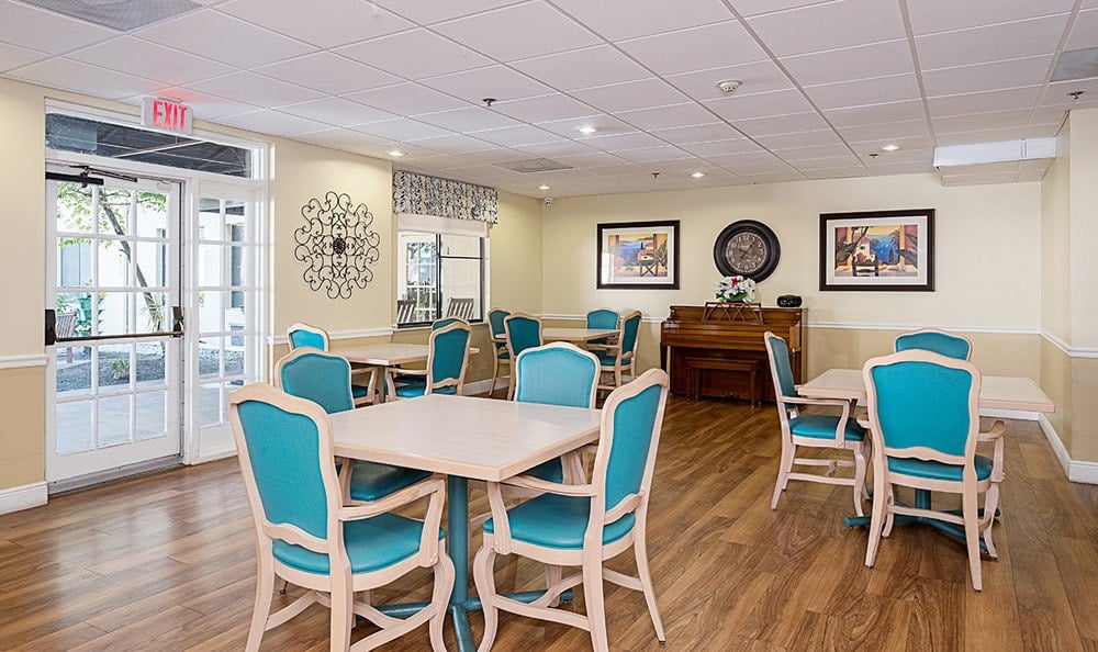 Dining hall with blue accents at Grand Villa of Dunedin in Florida