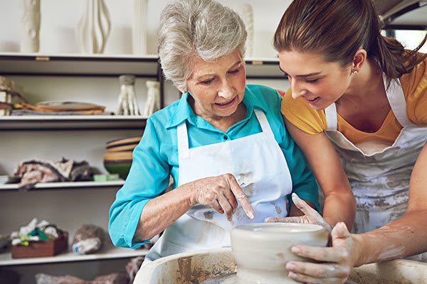 A nurse at one of our senior living communities assists a resident