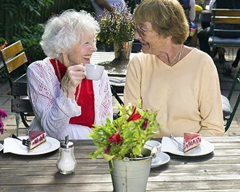 Happy friends eating lunch out and about at the senior living in Roseville