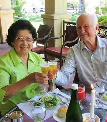 Residents toasting at a senior living community owned by Ray Stone Inc.