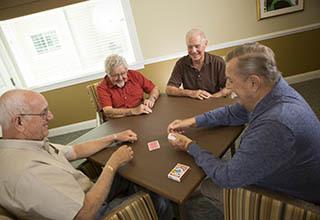 Senior living residents playing cards